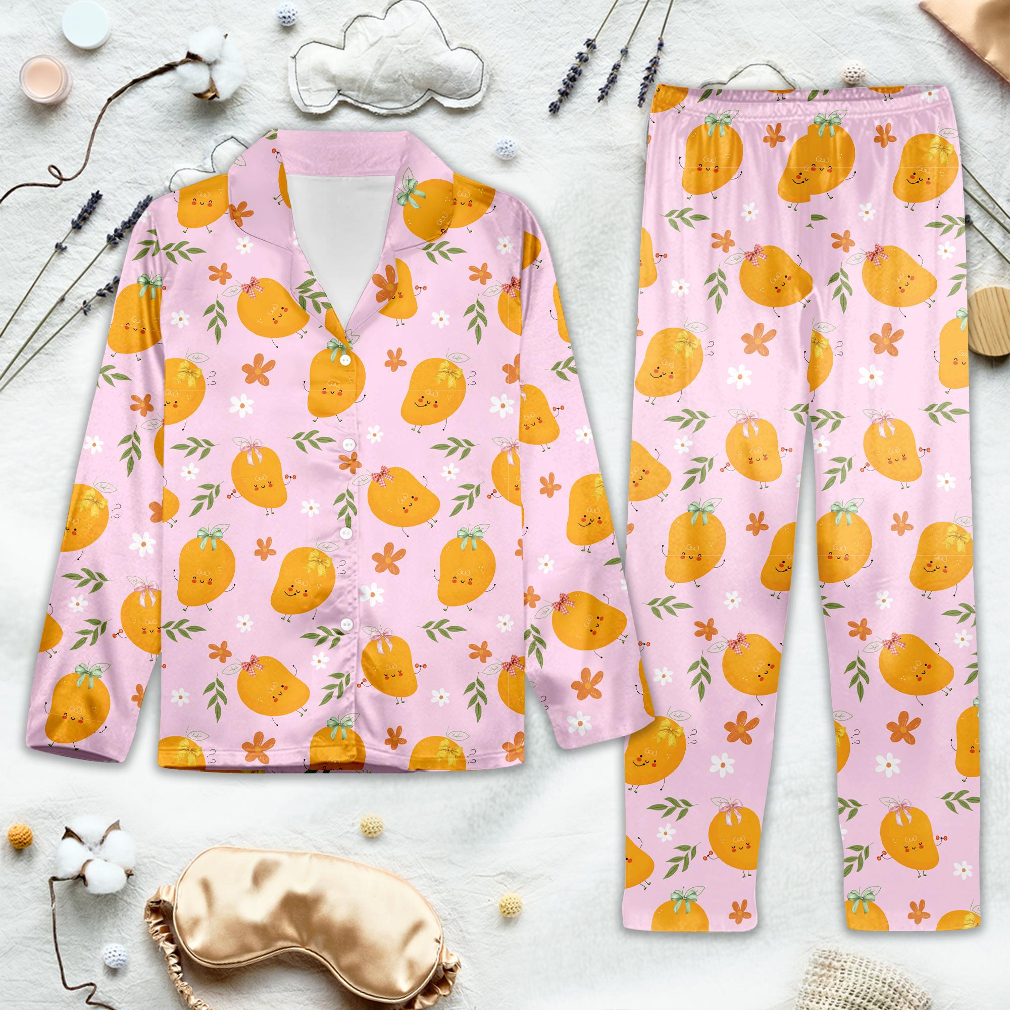 Sweet Mango Dreams Pajama Set. Pink pajama set with orange pumpkin pattern on a light gray background. 