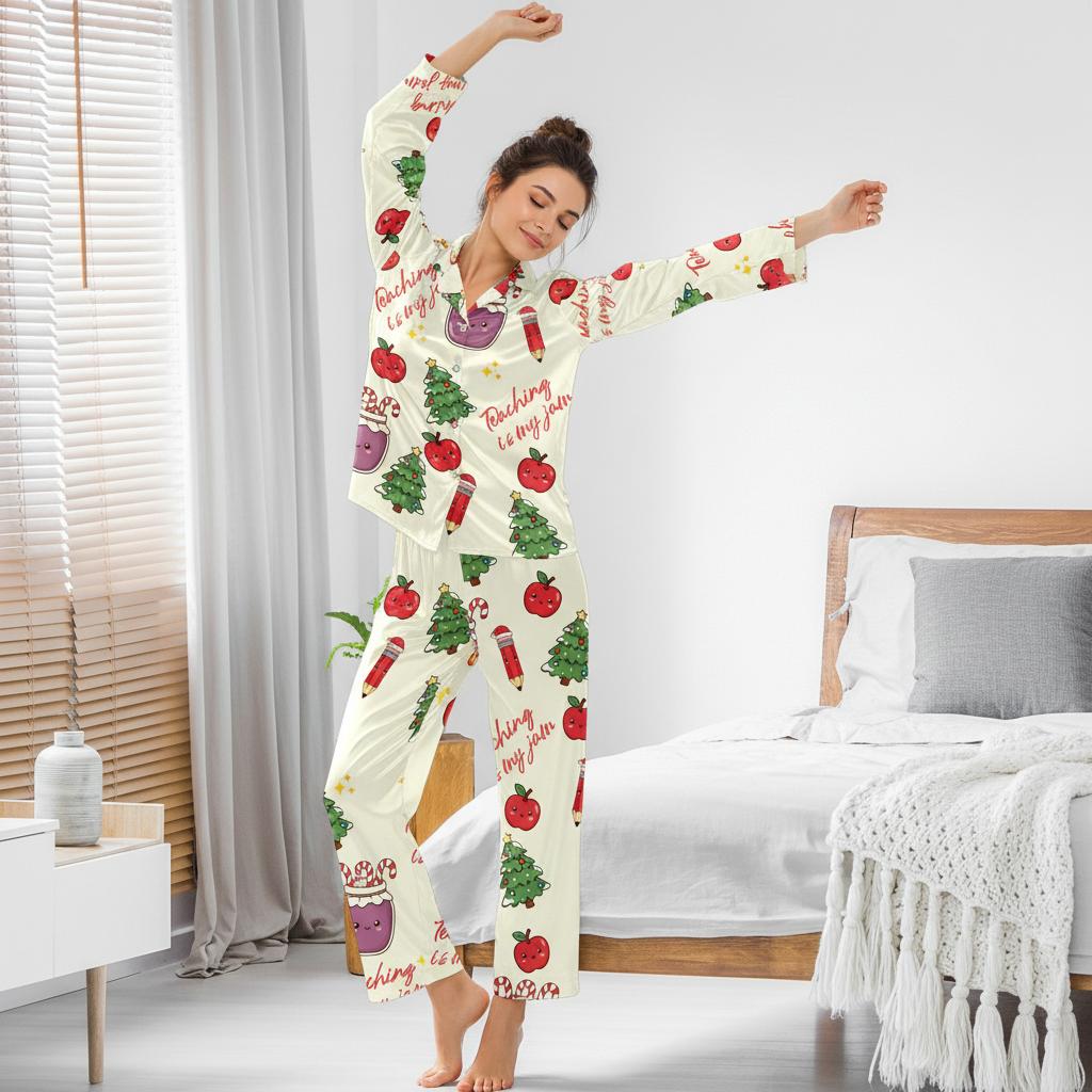 Woman wearing a pajama set with adorable Christmas graphics and little apples with Christmas-themed designs in a bedroom.