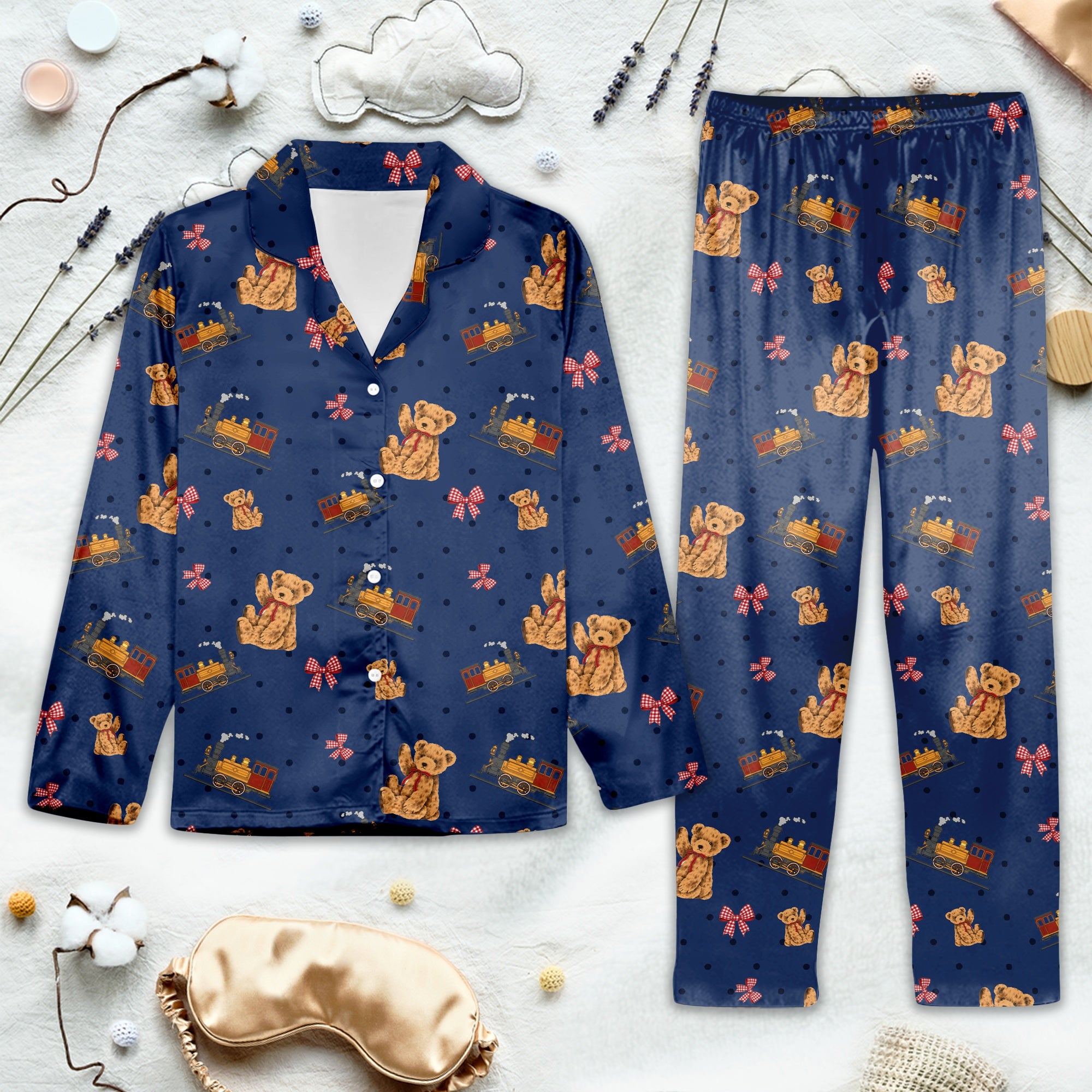Navy blue pajama set with teddy bear pattern on a light gray background