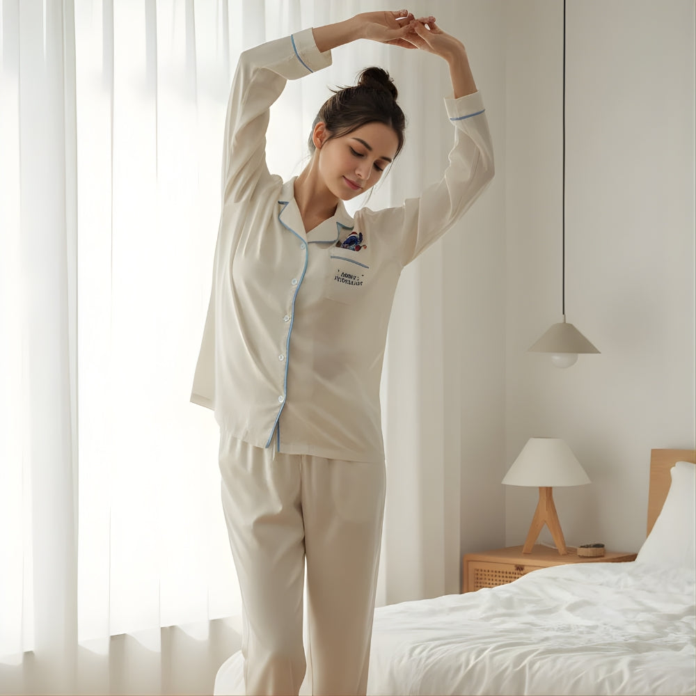 Woman in beige pajama set with Stitch in a Santa Claus outfit stretching in a bedroom