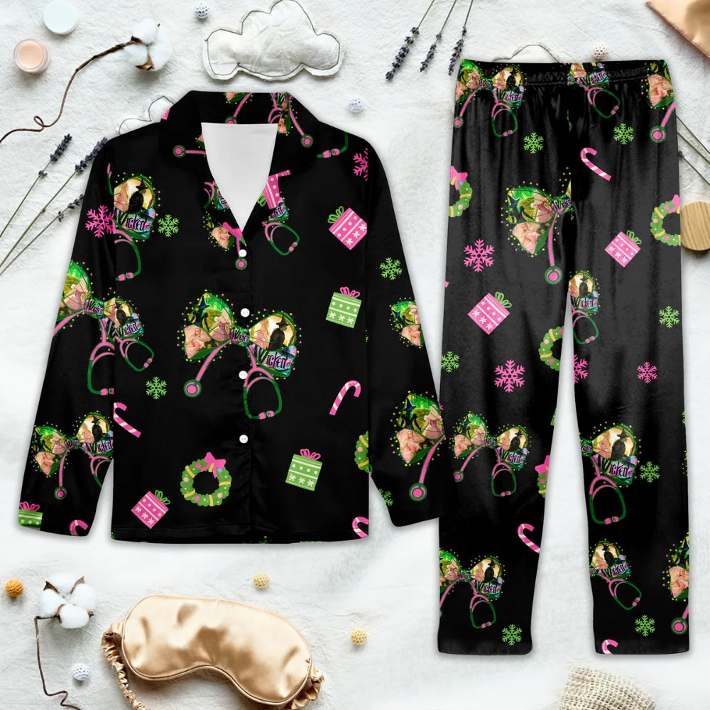 Black Christmas-themed pajama set with Wicked designs on a white surface with sleep mask and accessories.