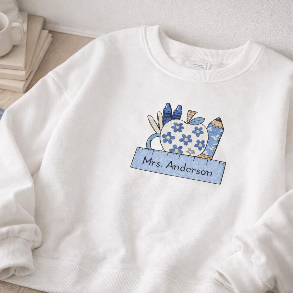 White sweatshirt with a colorful design and 'Mrs. Anderson' text on a light background