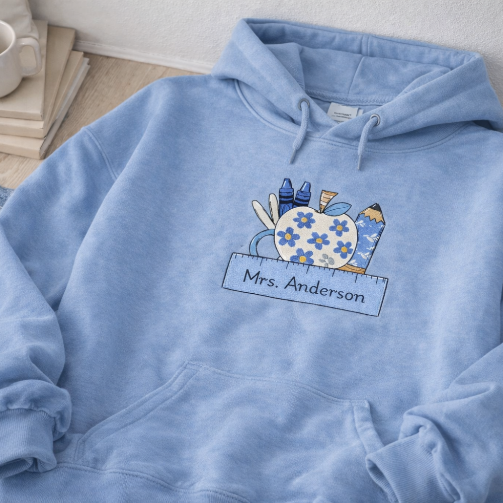 Blue hoodie with a colorful design and 'Mrs. Anderson' text on a light background